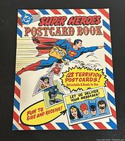 Front cover of 1981 DC Comics Super Heroes Postcard Book showing Superman flying delivering postcards.