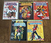 Five Captain Britain comic books displayed flat, showing full covers from #1 to #5 in sequence.