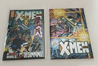 Front view of X-Men Alpha #1 and X-Men Omega comics showing foil covers and condition.