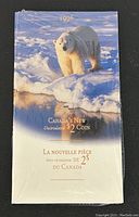 Sealed packaging with image of a polar bear on ice and text indicating 1996 Canada's new uncirculated $2 coin.