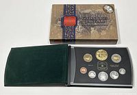 Photo of the closed and open outer box and green velvet case with the 8 coin proof set lying in place