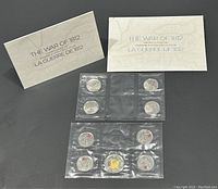 Full set of 9 coins in original sealed packaging with two informational booklets