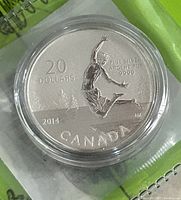 Close-up of the front side of the 2014 Canadian $20 Summertime silver coin showing embossing details, year, denomination, and purity markings.