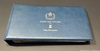 Blue faux-leather binder with silver imprint reading 'First Day Covers from Pobjoy Mint Limited'
