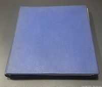 Closed blue hardbound stamp album