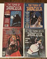 Four Marvel Comics The Tomb of Dracula magazines laid out flat showing front covers. The covers feature gothic vampire-themed artwork in colors with titles and issue numbers.