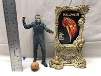 Michael Myers figure next to a ruler showing height about 7 inches alongside display stand