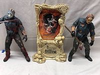 Full view of two horror figures and decorative frame with 'Movie Maniacs Canada' label and Jason artwork