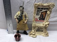 Full lot with ruler for scale, showing Leatherface figure, display stand, and bloody hand prop