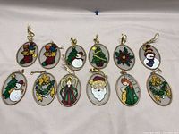 Lot of 12 stained glass Christmas ornaments displayed on a white surface
