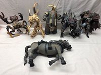 Photo showing all six Spawn figures and horse figure arranged on a neutral background for full lot overview.