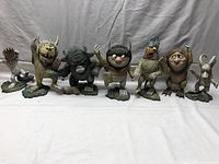 Full front view showing all 7 Wild Things figurines lined up on a white background.