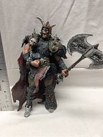 Front view of the Spawn Series 22 The Blood Axe figure with ruler for scale showing about 7 inches tall. Holding double-headed axe.