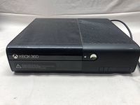 Front view of black Xbox 360 console showing the Xbox 360 logo, glossy finish, and power button off.