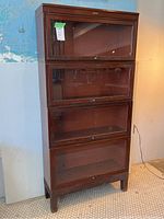 Front view of four-stack barrister bookcase with glazed drop-front doors