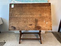 Front view of drafting table with angled top and oak trestle base