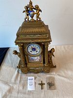 Full view of clock with two winding keys and pendulum