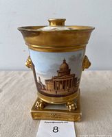 Front view of bough pot showing architectural scene and gilt rim