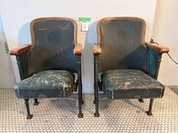 Front view of two theatre chairs side by side showing overall design, upholstery, and condition