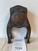 Front view of oak desk clock showing copper overlay dial with floral Art Nouveau design