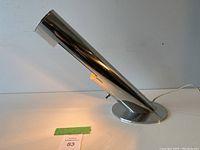 Front-right angle view of lamp showing cylindrical head and round base