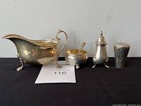 All four items arranged on black cloth with lot number card