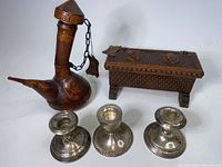 Vintage primal leather decanter, primal leather trinket box, and three small sterling silver candle holders grouped for scale and identification of lot contents.