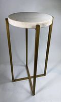 Full view of the vintage side table showing white quartz top and brass legs support.