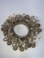 Top view of the vintage stretch bracelet showing tightly clustered faux pearls, clear faceted beads, and gold-tone filigree beads around the expandable silver-tone band.