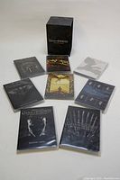 Photo showing all individual DVD cases laid out with unique cover art and the outer box