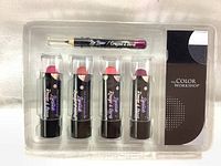 Full set of four lipsticks and one lip liner pencil in clear plastic tray with black and white branded insert.