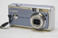 Front view showing camera lens, flash, and blue front panel with Canon branding and PowerShot A400 model name.