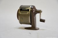 Side profile of the vintage Sanford Giant hand crank pencil sharpener showing the crank handle and body.