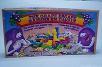 Front box cover of The Grape Escape game showing colorful cartoon grapes and title.