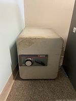 Full view of the Sentry fireproof safe model 6250 showing its front combination dial and handle, with noticeable wear and discoloration on the top corner.