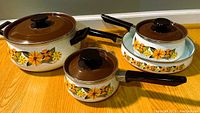 Full view of all 7 pieces including three lidded pots/pans and two shallow pans