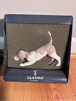Porcelain beagle puppy figurine in hunting pose displayed in original box with foam padding.