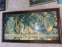 Framed Maxfield Parrish lithograph showing green and cream tones with three women seated by water, large urns in background, in carved wooden frame.