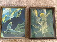 Two framed lithographs by Maxfield Parrish titled Wild Geese and The Canyon placed side by side on a carpeted floor.