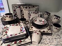 Full set of Mikasa Desert Bloom stoneware dish set showing all plates, bowls, and mugs with floral design and square shape.