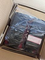 Photo of AirClimber parts inside original cardboard box still wrapped in plastic.