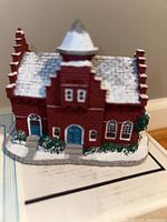 Front and side view of the detailed 'The Town Offices' building sculpture with snow effect on roof and surrounding greenery.