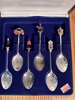 Set of six silver plated souvenir spoons with enamel 3-D British-themed toppers in blue velvet-lined original 'Exquisite' branded box.