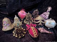 Overview of all 9 vintage Christmas ornaments arranged for display showing variety of shapes, colors, and textures.