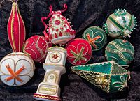 Group view of the 10 vintage Christmas hanging ornaments in red, white, and green with detailed beadwork and fabric materials
