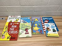 Seven Dr. Seuss and related children's books arranged on a table, showing cover art and titles clearly.