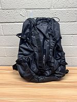 Front view of black Skyline 9.0 backpack showing overall design, shoulder straps, and front compartments.