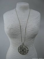 Full view of the necklace on a display bust showing chain length and pendant size.