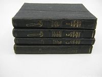 Four black hardcover Audels Carpenters and Builders Guide books stacked showing spines with gold text and hammer icon.