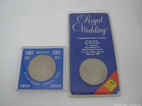 Photo showing both commemorative coins in their holders, one marked Royal Wedding with blue and red packaging, the other the 2004 Entente Cordiale Centenary coin in a blue holder.